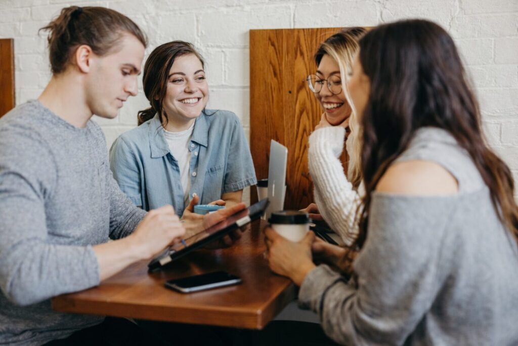 College students studying together with laptops, notebooks and AI study tools